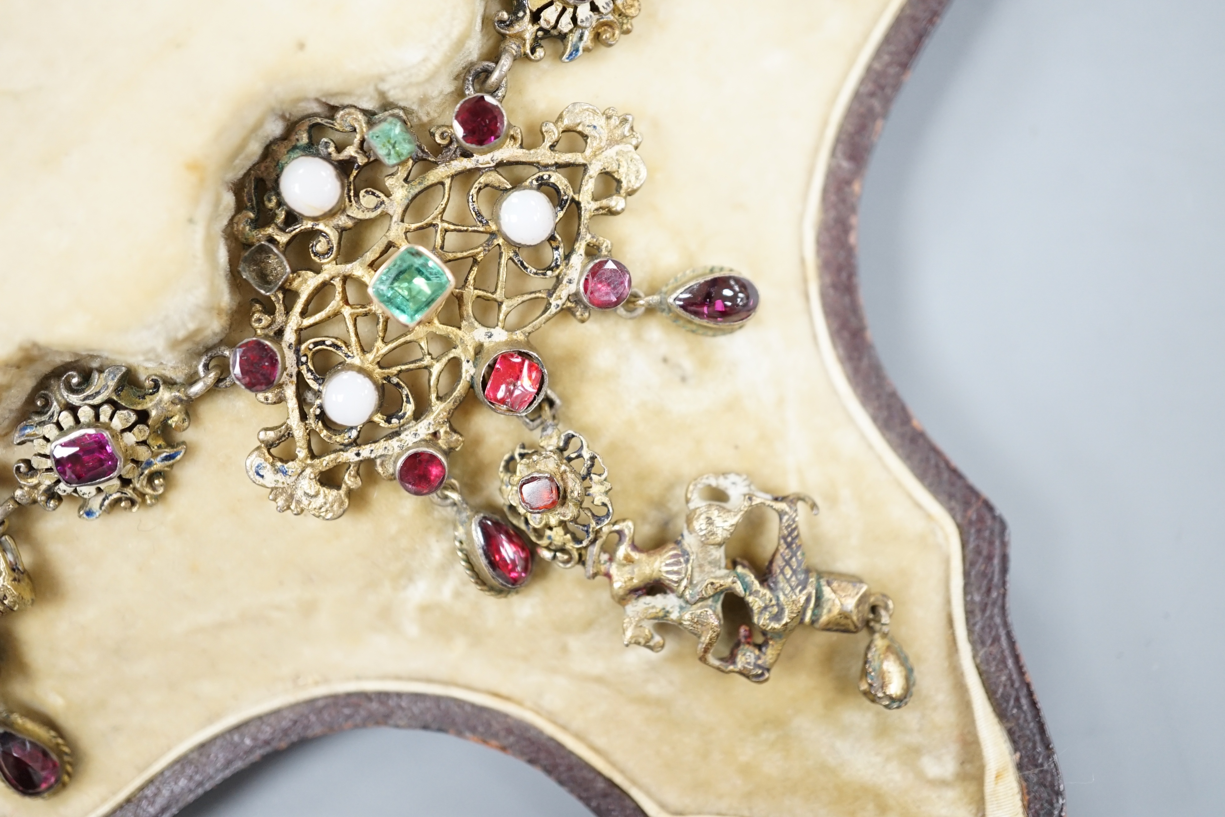 A 19th century Austro-Hungarian? gilt metal, gem, enamel and paste set drop fringe necklace, 36cm, in fitted box.